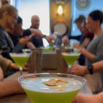 A group making appletinis around a wooden table